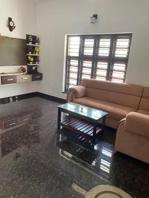 a living room with a couch and a coffee table at Travango Settukunnu in Vythiri