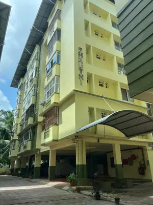a large yellow building with a building at Guruvayur Soorya Madhavam Apartment B10, Shruthi, close to Temple, only150 Mtrs to North Nada in Guruvāyūr