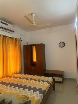 a bedroom with a bed and a ceiling fan at Guruvayur Soorya Madhavam Apartment B10, Shruthi, close to Temple, only150 Mtrs to North Nada in Guruvāyūr