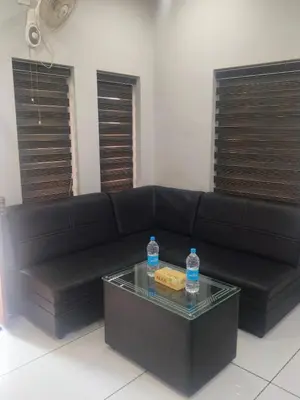 a black couch with two water bottles on a table at Havence Villas - Kottakkal in Kottakkal