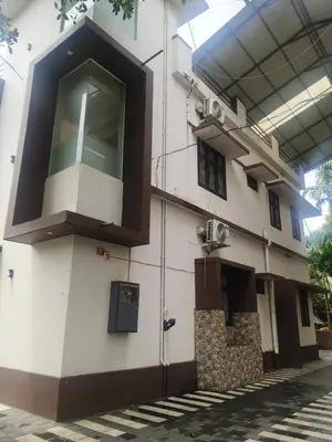 a building with a balcony on the side of it at Havence Villas - Kottakkal in Kottakkal