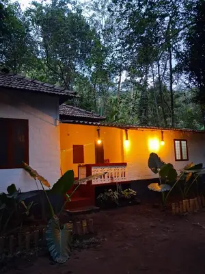 a house with lights on the side of it at Pookie stay athirapilly in Athirappilly