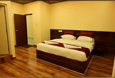 a bedroom with a large bed in a room at Ridhis Stay in Virajpet