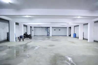 an empty garage with a motorcycle parked in it at Hotel Aranmanai in Coimbatore