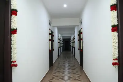 a corridor of a building with christmas decorations at Hotel Aranmanai in Coimbatore