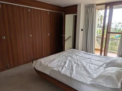 a bedroom with a bed and a large window at Auric by Hillton in Mysore
