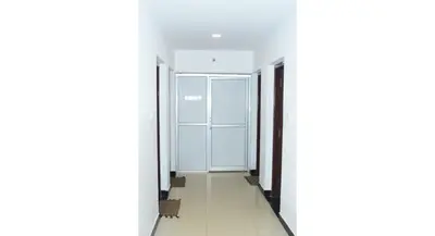 an empty corridor of an office building with glass doors at HS Cottage Ooty in Ooty