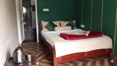 a bed in a room with a green wall at Hanni Resort in Kotagiri