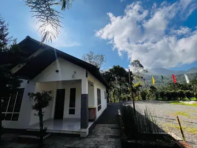a small white building with a fence in front of it at Bambus Alley in Wayanad