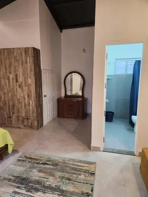 a living room with a door and a mirror at The Lake House Ooty in Ooty