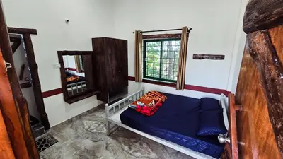 a room with a bunk bed and a mirror at Nature's Spark Resort in Sivasamudram