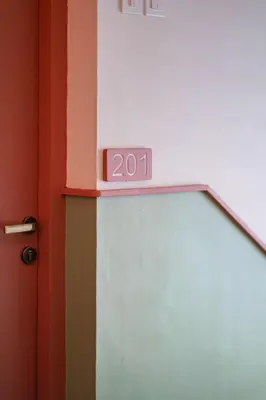 a clock on top of a wall with a door at Sreenivas Lodge by Copperfolia in Kozhikode