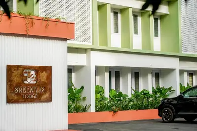 a black car parked in front of a building at Sreenivas Lodge by Copperfolia in Kozhikode
