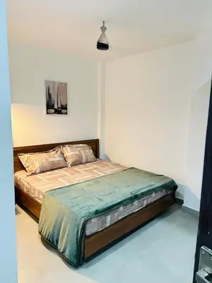 a bedroom with a large bed in a room at ZAHIR RESIDENCY calicut in Kozhikode