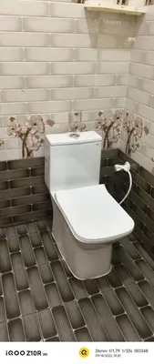 a bathroom with a white toilet in a room at S M LODGe in Dharmapuri