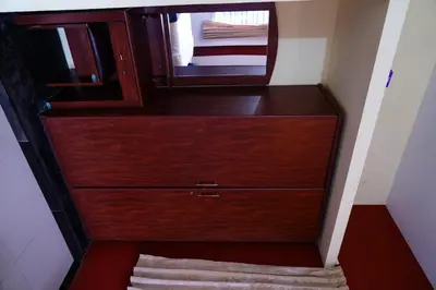 a large wooden dresser with a mirror on it at KP Holidays తెలుగు Cottage in Ooty