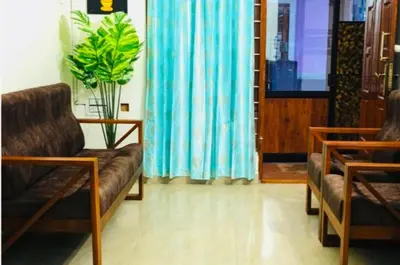a living room with two chairs and a couch at Aps inn munnar in Munnar