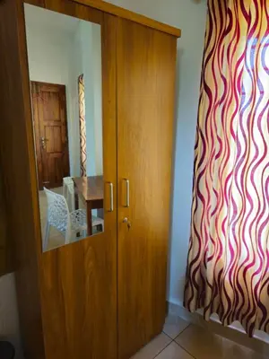 a door to a dining room with a red and white wall at RF Tower Lodge in Kozhikode