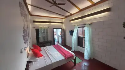 a bedroom with a bed with red pillows on it at 36 Palms Heritage Villa in Cochin