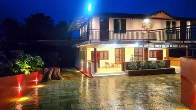 a house lit up at night with lights at Hermitage in Kurchi