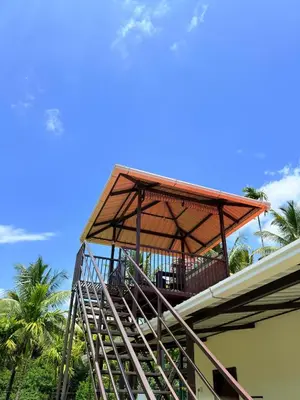 a balcony on top of a building with a roof at Horegallu Homes in Agali