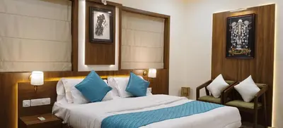 a bedroom with a large bed with blue pillows at Radha Madhavam Apartment's in Guruvāyūr