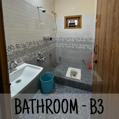 a bathroom with a sink and a toilet at Ambassador Inn in Kodaikānāl