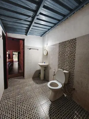 a bathroom with a toilet and a sink at The Big Cat's Den - Maravakandy Resort, Masinagudi in Masinagudi