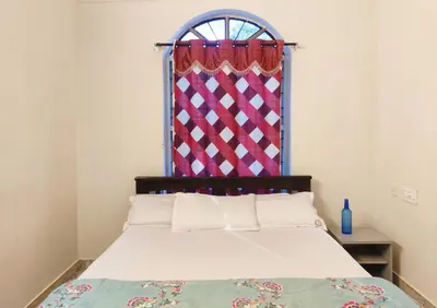 a bedroom with a bed with a window at Spacious #3BHK Home Stay in Central Mysore in Mysore