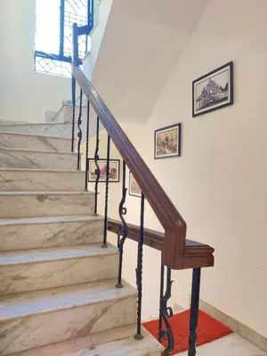 a staircase in a house with a wooden stair case at Spacious #3BHK Home Stay in Central Mysore in Mysore