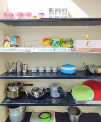 a pantry with shelves filled with different types of food at Spacious #1BHK Home Stay in Central #Mysore in Mysore