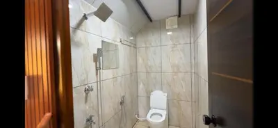 a bathroom with a toilet and a shower at damora in Mannārakkāt