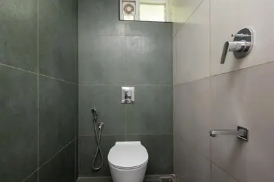 a bathroom with a toilet and a shower at Simqo By Nexa Hotels Group in Kozhikode