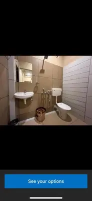 a bathroom with a toilet and a sink at Rocks beach house in Kannur