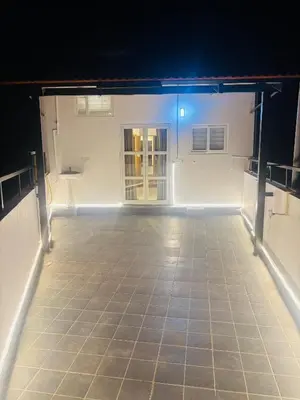 an empty room with a tile floor and a blue light at Sihi Homes in Mysore