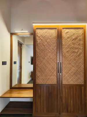 a pair of wooden doors in a room with a mirror at Birdwing - Experiential Farmstay Resort by GoodEarth