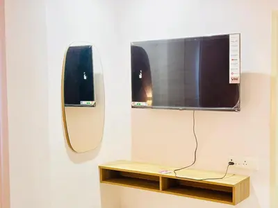 a flat screen tv hanging on a wall at Elegant Residency in Coimbatore