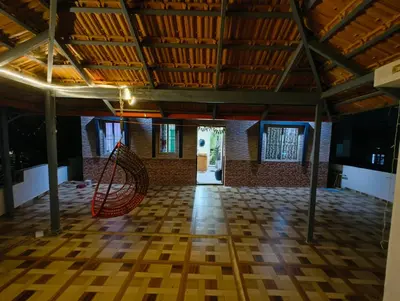 a room with a wooden floor and a wooden ceiling at Coorg Refresh Homestay in Kushālnagar