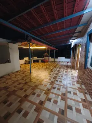 an empty room with a wooden floor and a ceiling at Coorg Refresh Homestay in Kushālnagar