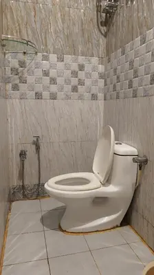 a white toilet in a bathroom with a shower at Happy Villa By Eden Luxury Stay in Ooty