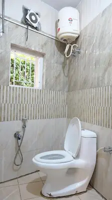 a bathroom with a white toilet and a shower at Happy Villa By Eden Luxury Stay in Ooty