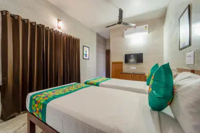 a bedroom with a large bed and a television at Treebo Dunag in Coimbatore