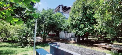 a bench in front of a house with trees at Nature stay GF in Hārohalli