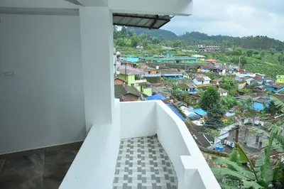 a balcony with a view of a city at Murugan Homestays in Vālpārai