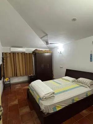 a bedroom with a bed in a room at SARA fARM STAY