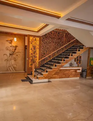 a staircase in a building with a painting on the wall at Akshaya Homestay in Trichūr