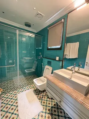 a bathroom with a sink and a shower and a toilet at Hanberry Luxury Cottage in Kalpetta