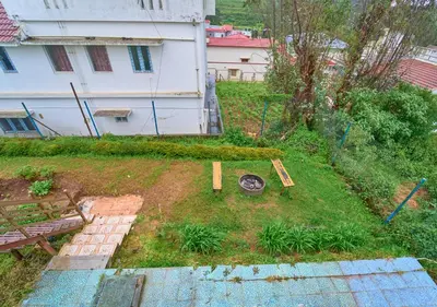 an aerial view of a yard with a bench at Pine Forest View Ooty by VOYE HOMES in Ooty