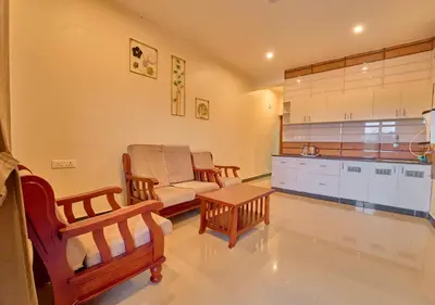 a living room with a couch and a table at Pine Forest View Ooty by VOYE HOMES in Ooty