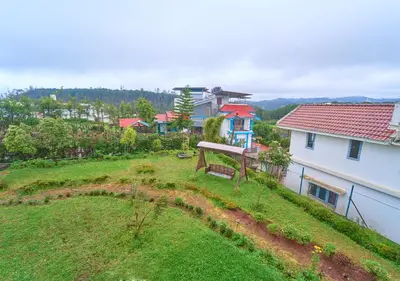 an aerial view of a yard with a house at Pine Forest View Ooty by VOYE HOMES in Ooty